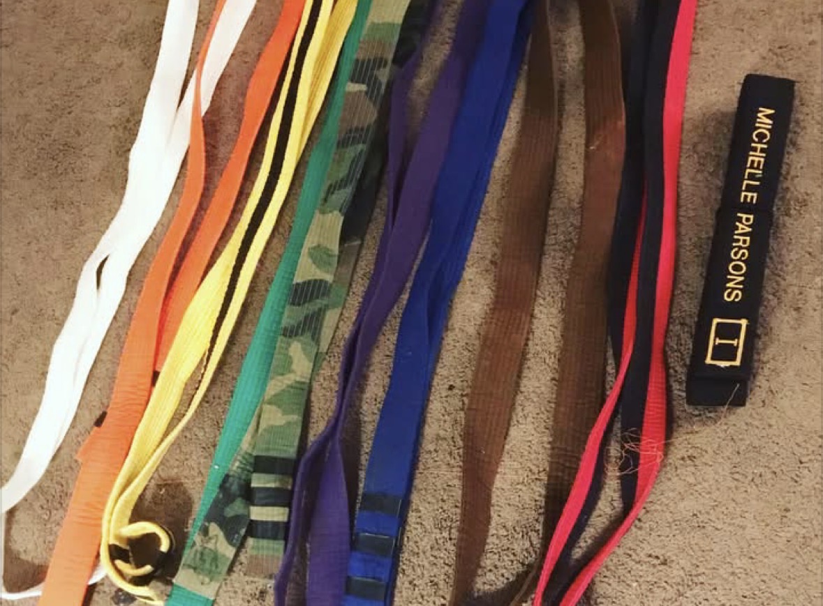 A collection of martial arts belts from Michelle’s training journey.