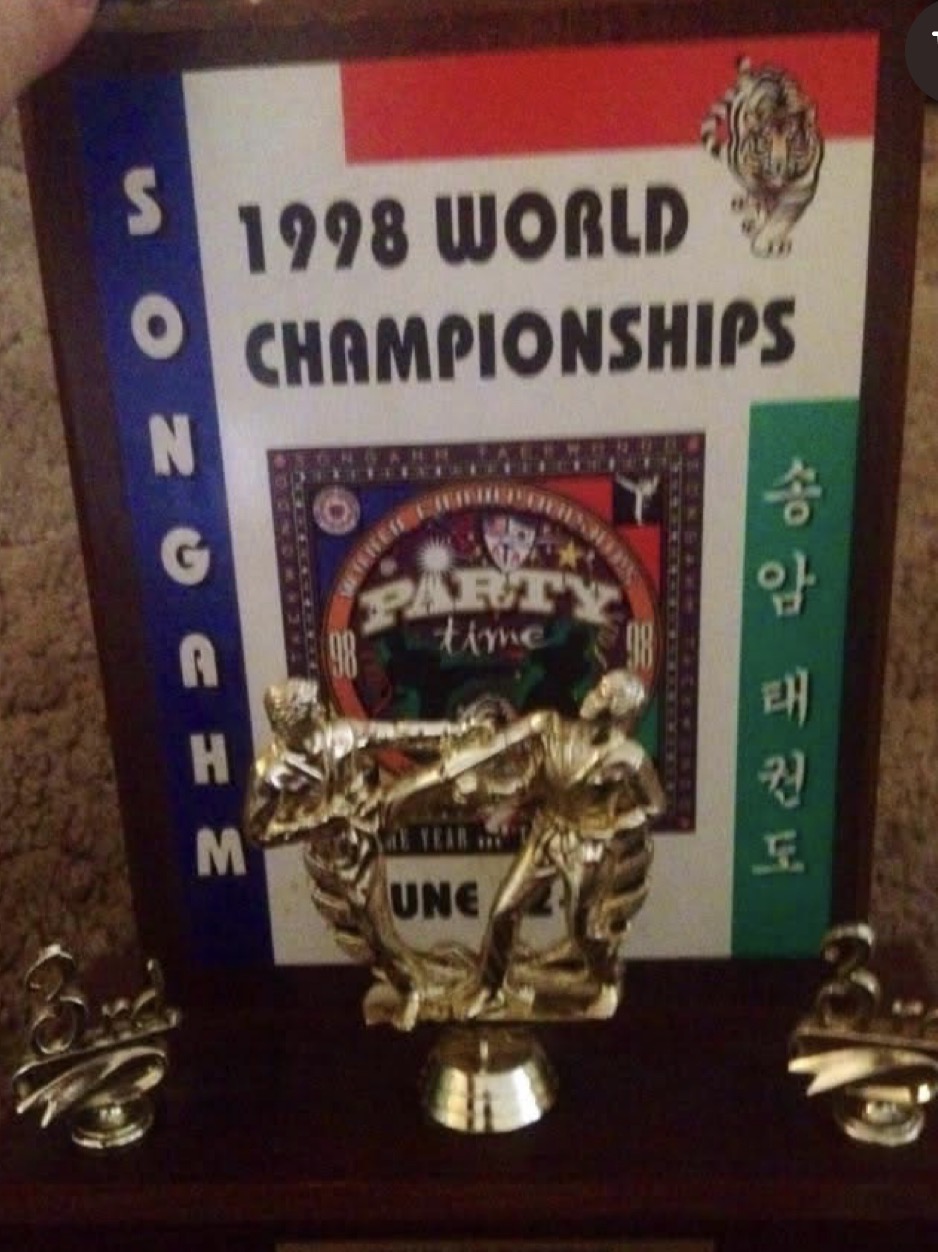 A 1998 World Championships keepsake and martial arts trophy.